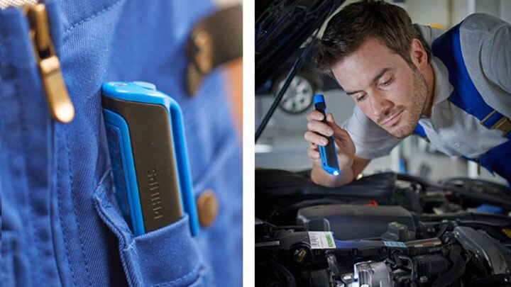 Un homme examine le moteur d’une voiture à l’aide de la lampe-stylo à DEL de Philips