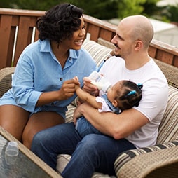 Couple feeding baby